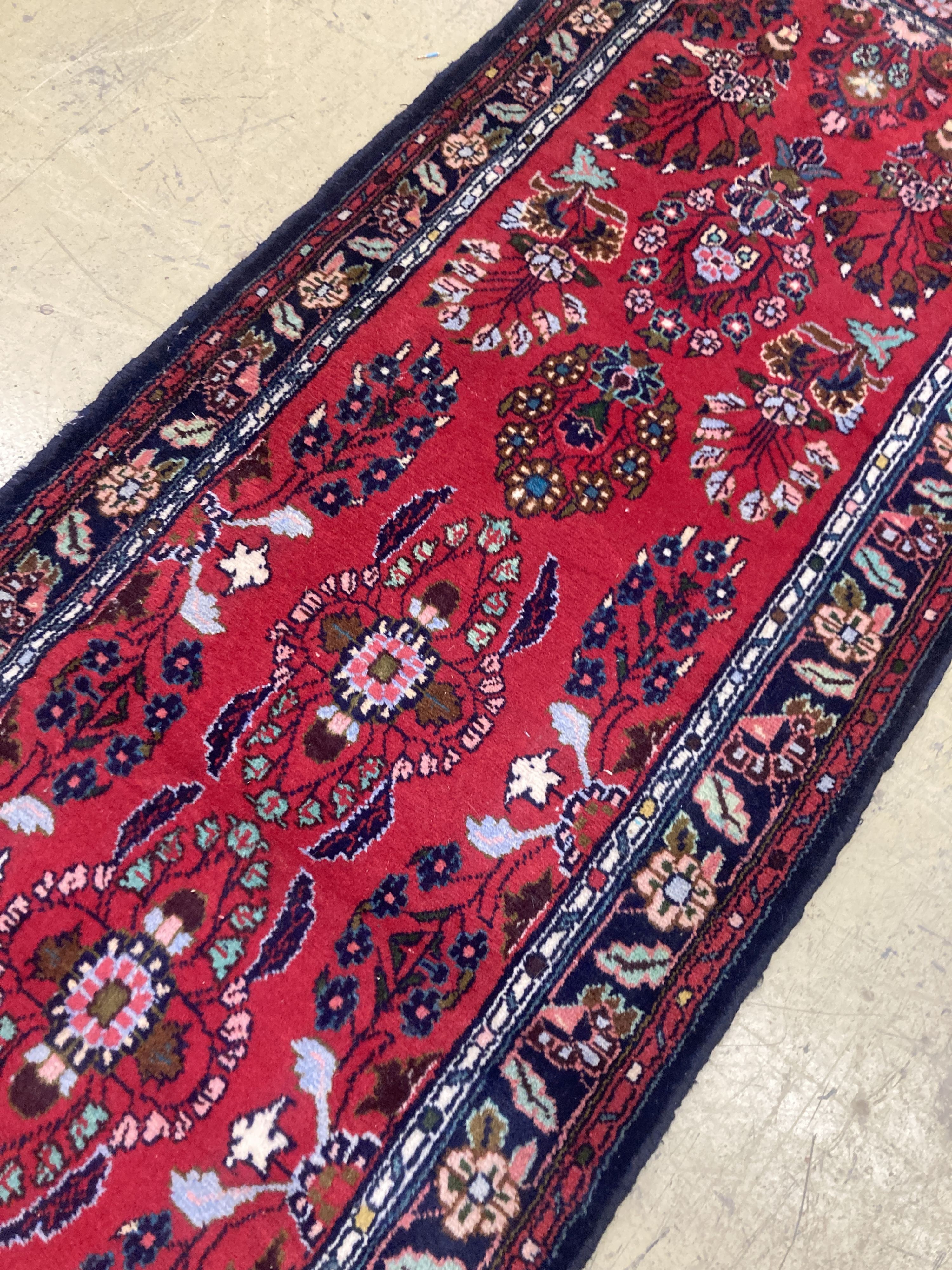 A Hamadan red ground runner with floral design, 280 x 84cm